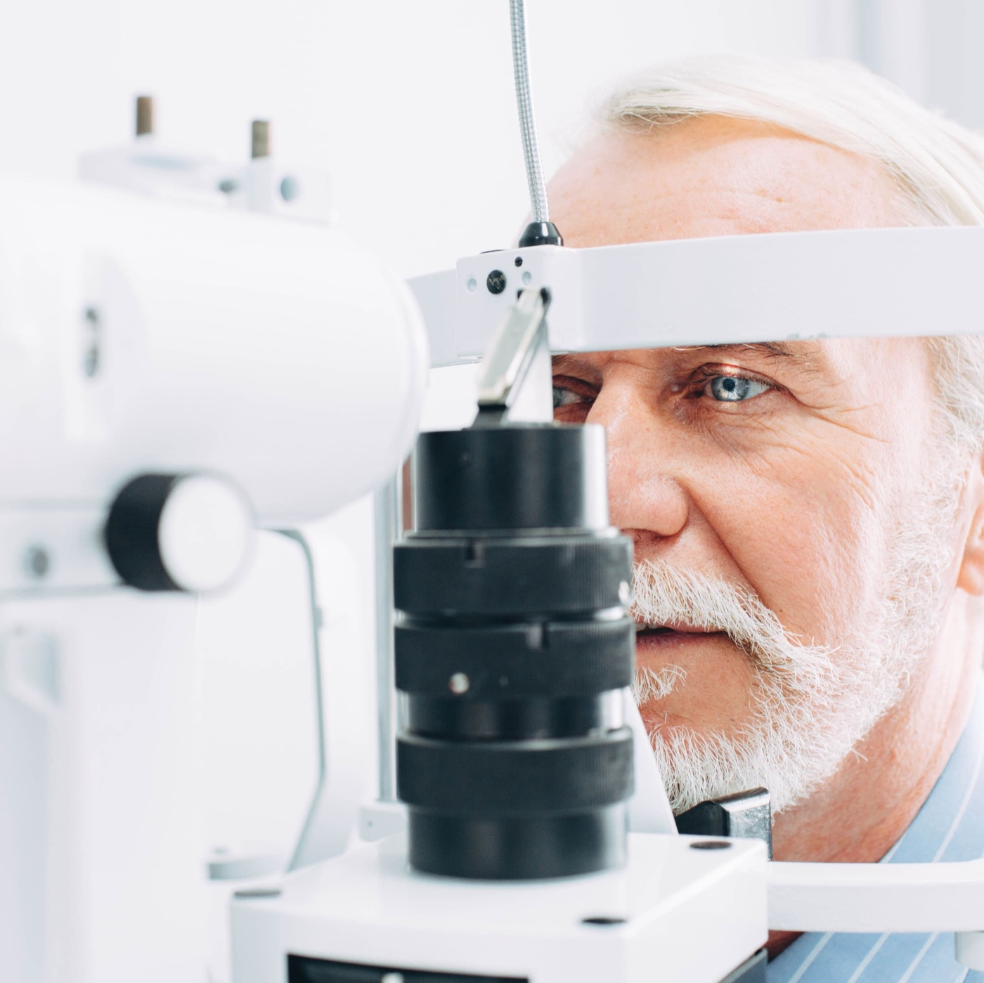 Eye examination of man with slit lamp microscope