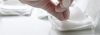 Sterile swabs being removed from packaging with gloves