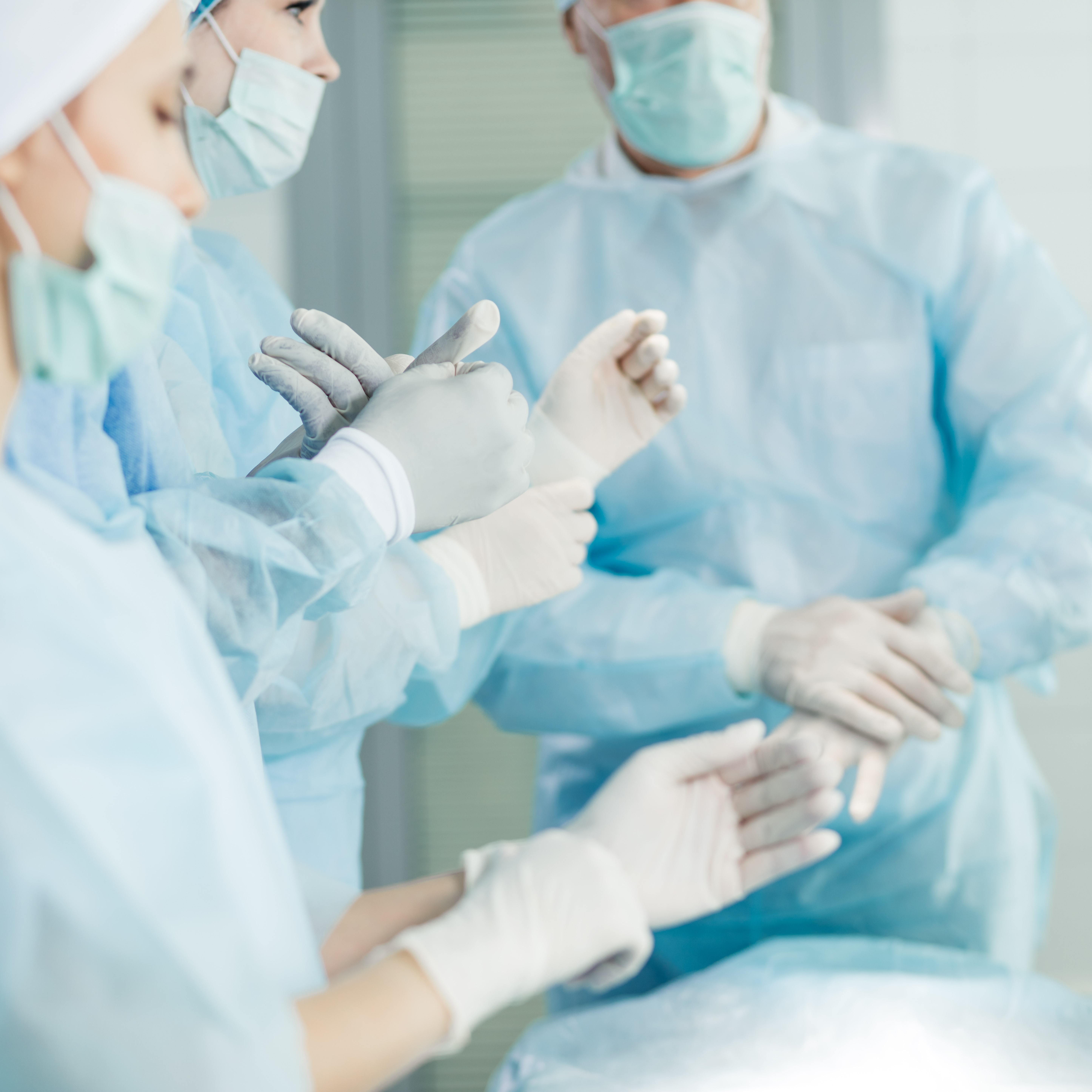 Medical personnel putting on medical protective equipment